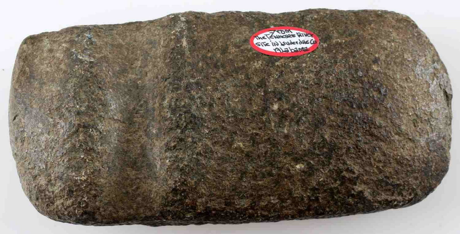 NATIVE AMERICAN STONE GROOVED AXE GRANITE: Rough texture grooved ax, measures 6.75 inches long. Sticker reads 'From the Tennessee River site in Lauderdale Co, Alabama.' Good condition.