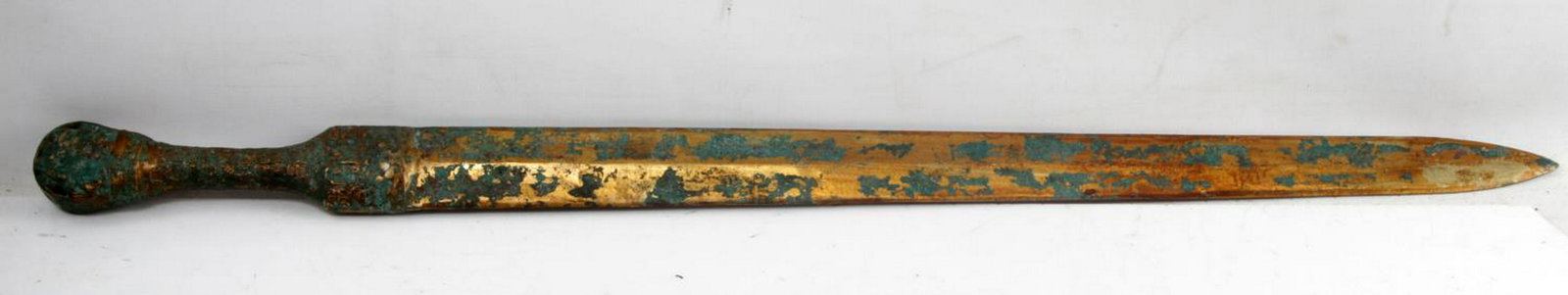 ANTIQUE ASIAN BRONZE SHORT SWORD: Short bronze sword which appears to approximate a Chinese or Korean bronze short sword. The entire thing measures 26.5 inches in length. The decorated grip and handle are made of the same piece. Some 