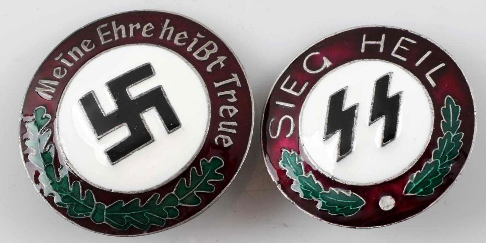 WWII GERMAN SS & NSDAP PARTY BADGE LOT OF 2: This lot includes 1 SS Sieg Heil badge and 1 German NSDAP party badge. Both screw back versions and RZM SS marked at reverse. Nickel construction with enamel. Good overall. This lot has a reserve.