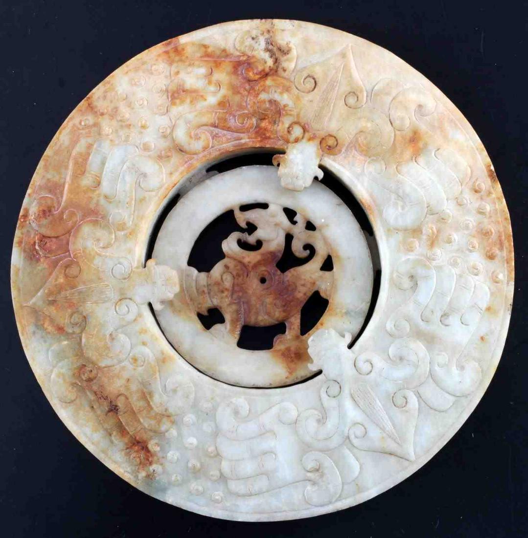 DRAGON DECORATED 2 PART CHINESE JADE BI DISC: Chinese jade bi disc with carved dragon decoration around ring. Inner circle rotates and has carved dragon at center. Green and orange toned. Measures 21.5 inches in circumference. In good condition w