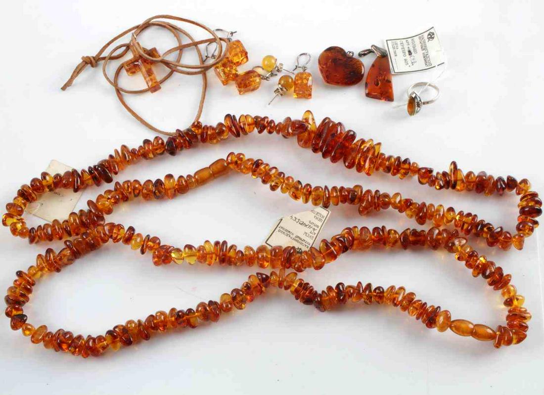 12 AMBER PIECES SOVIET BALTIC KALININGRAD JEWELRY: Two amber bead necklaces. Each measures approximately 24 inches. Cross pendant, heart pendants, abstract pendant, one size 6 ring, two sets of amber stud earrings and two sets of amber dangle earrings
