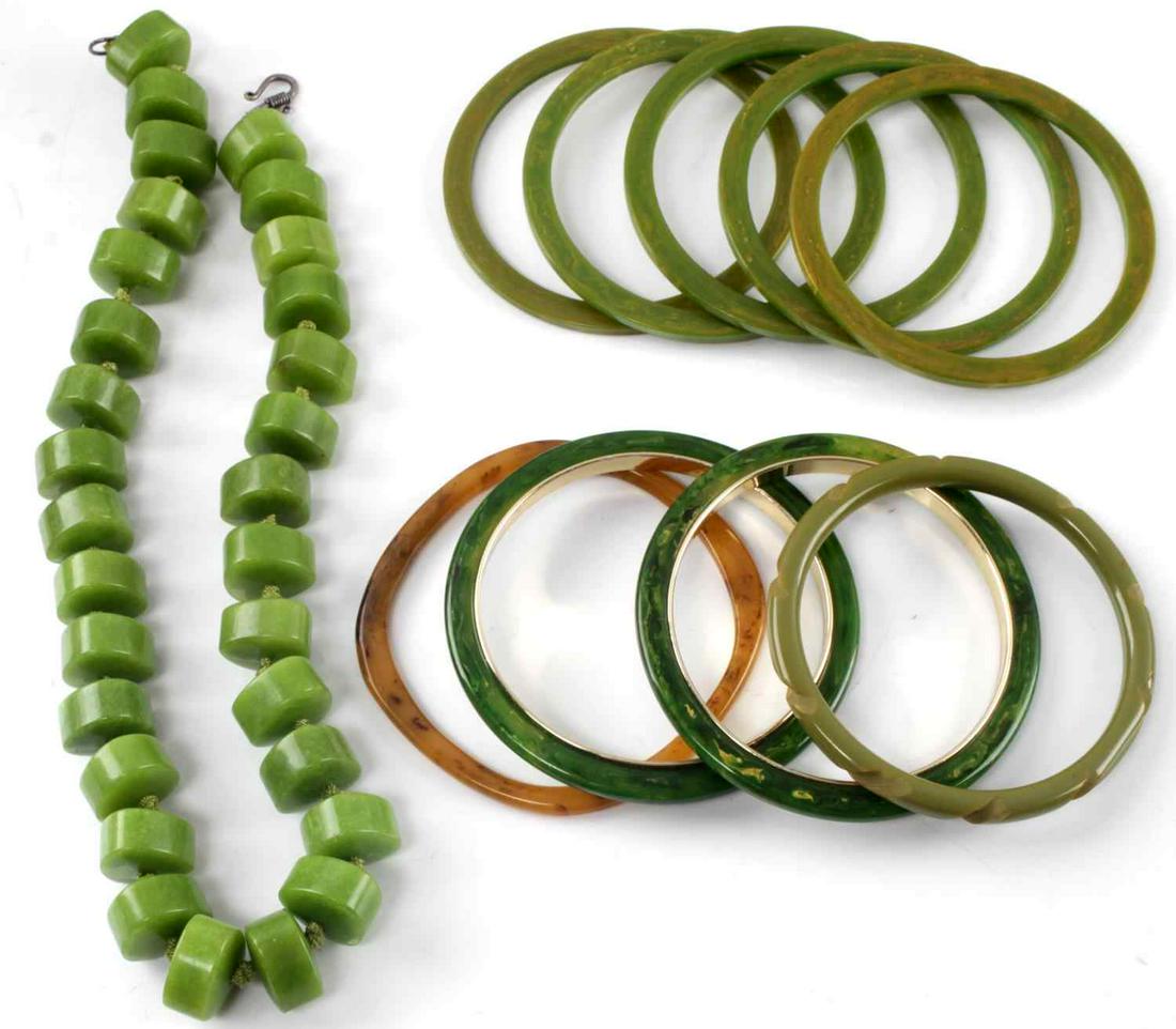 MID CENTURY JEWELRY BAKELITE BRACELETS & OTHER: Nine American bakelite bracelets. Eight in green tones and one in an Amber tone. One lime green stone necklace. Measures 18 inches. All in good condition.
