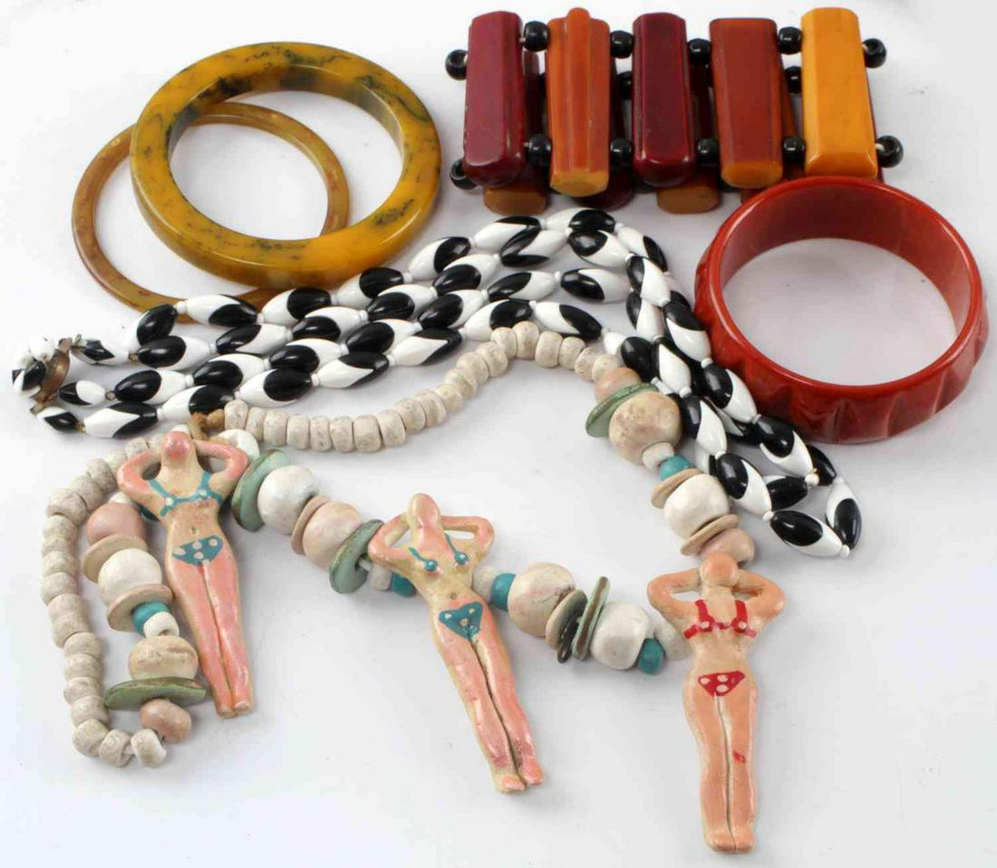 MID CENTURY JEWELRY LOT AMERICAN BAKELITE & MORE: Mid-century kitsch necklace. White, blue and pink beads of various shapes and sizes with three ceramic sunbathing ladies wearing bikinis. Unique and fun statement piece! Measures 24 inches. In good co