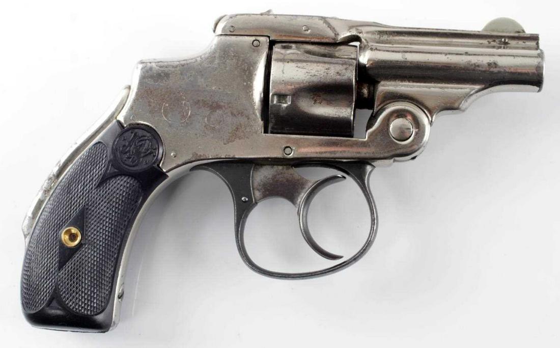 S&W NEW DEPARTURE HAMMERLESS REVOLVER .32 CF: AKA lemon squeezer double-action 5 shot revolver, maker and patent dates to top of barrel with Aug 4, 85 as the last. Barrel measures 2 1/8 inches long with fair bore. Nickel finish has some loss. One