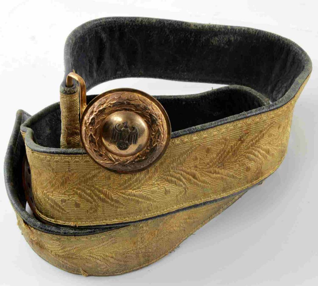 WWII GERMAN THIRD REICH EARLY HIGH RANK NSDAP BELT: Early belt and buckle used by a high-ranking NSDAP official. Gold bullion wire brocade front with blue leather backing. Has a brass belt buckle with a Reichsadler affixed to the front. In very good co