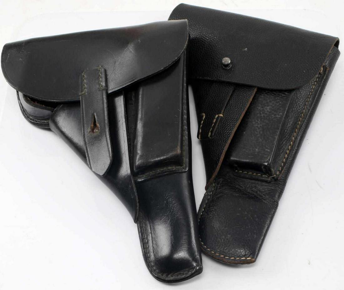 WWII GERMAN THIRD REICH P38 HOLSTER LOT OF 2: Lot includes 2 German P-38 holsters. Non-textured one is named on interior in ink "Schmidt. G." and marked "1928." Textured version reverse marked "Jkh 4." Full leather construction and in good condit