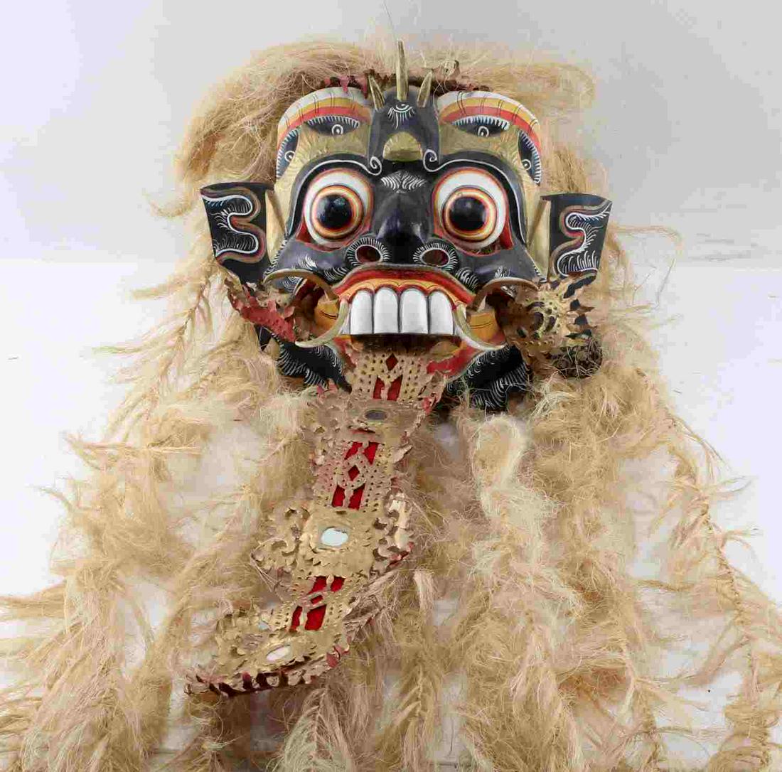 EAST ASIAN BALINESE RANGDA CEREMONIAL DANCE MASK: Painted wood Rangda ceremonial mask with stylized plant fiber mane. Measures 30" in length. Good overall. Some signs of use present.