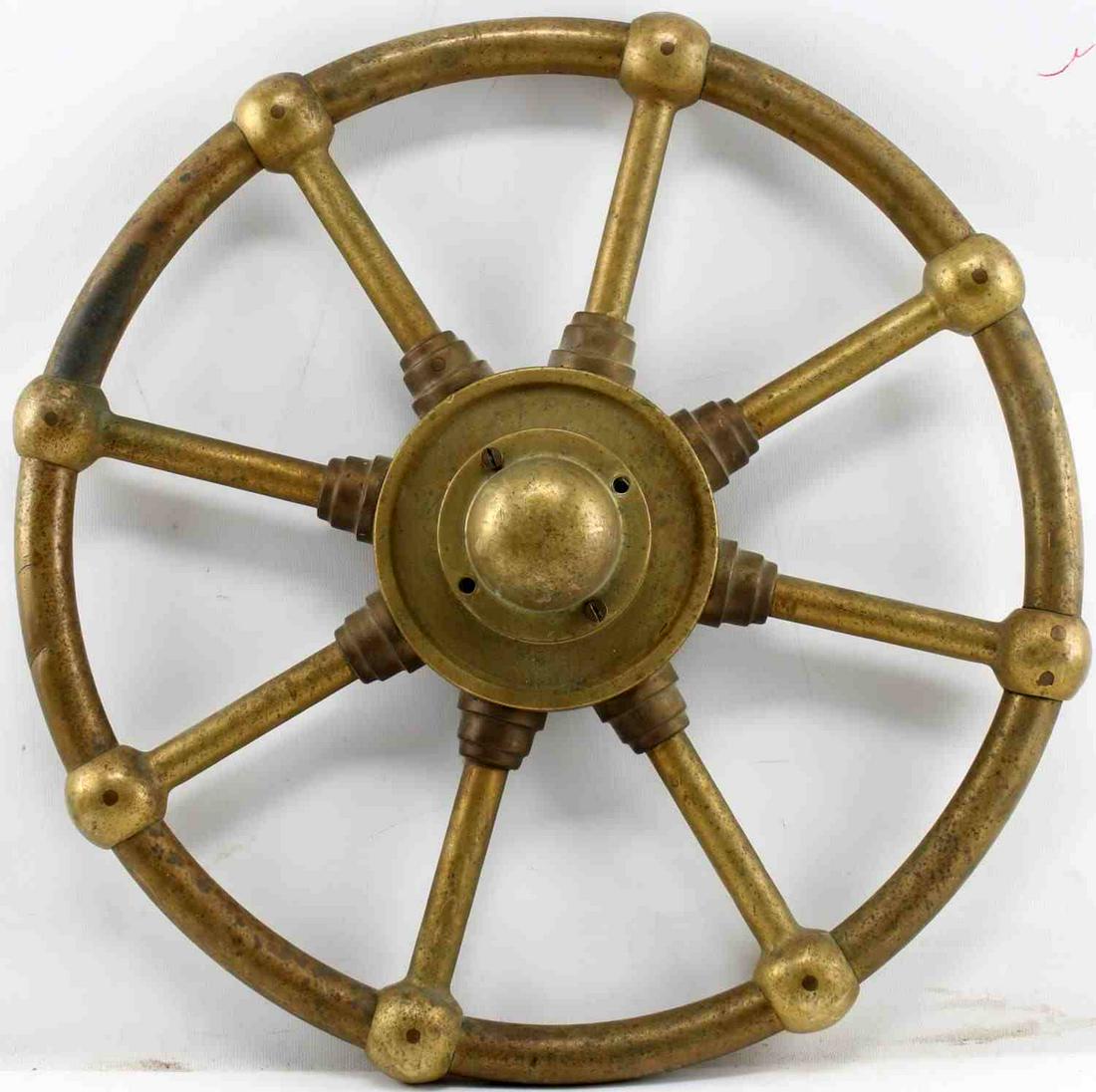 ANTIQUE BRASS STEAM OR WATER VALVE WHEEL: Brass wheel believed to be for an antique steam or water valve. Measures 19 inches in diameter. In very good condition with minor denting and slight tarnish. In very good condition.
