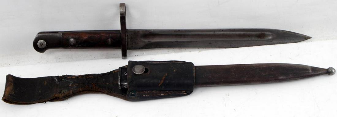 WWI IMPERIAL GERMAN M1871 MAUSER BAYONET: Knife bayonet for use with the 11 mm. Mauser M1871/84 repeating rifle. Complete with scabbard and leather frog. Good condition overall. Some small dents to scabbard and wear present. This lot has a re