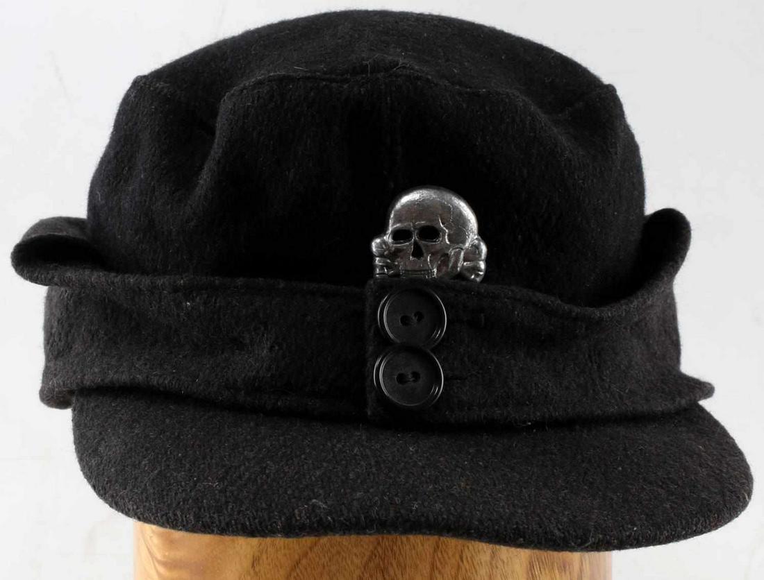 WWII GERMAN THIRD REICH WAFFEN SS M43 FIELD CAP: German Waffen SS M43 field cap. Black wool construction with affixed totenkopf badge. Faint ink manufacturer mark present inside, however it is largely indiscernible. Some mothing present under bill. 