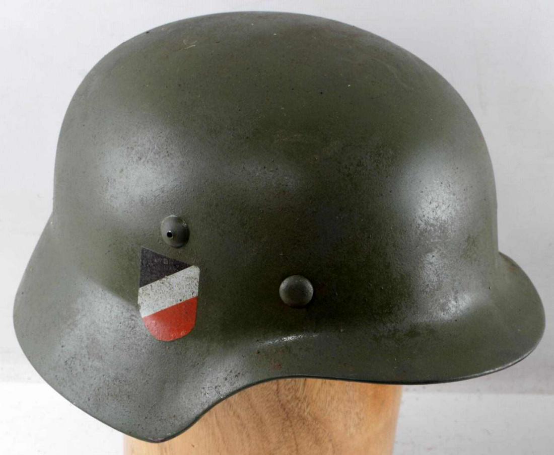 WWII GERMAN ARMY DBL DECAL M40 HEER HELMET: Painted green steel body, national tri-color shield decal to right ear, eagle decal to left ear. 9 finger leather liner marked 68 Heisler. Chinstrap present. ET68 stamped inside left ear. Good conditi