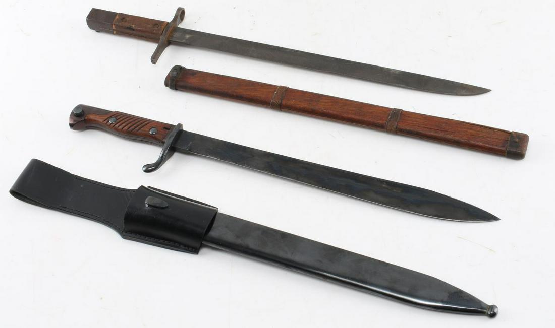 IMPERIAL JAPANESE ARISAKA RIFLE BAYONET LOT OF TWO: Lot contains two Imperial Japanese Arisaka bayonets. One is an older bayonet with a Jinsen Arsenal mark and a wooden scabbard. The second one has a metal scabbard and leather frog, but lacks any maker