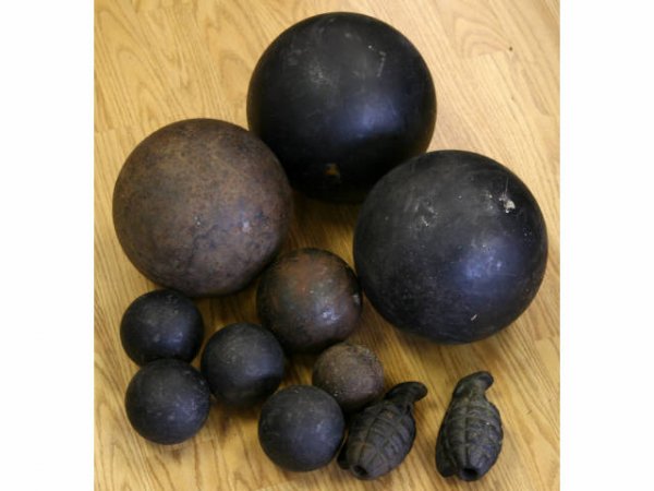 WWII PRACTICE GRENADE & CIVIL WAR CANNON BALL LOT: This lot consists of 2 WWII inert training grenades and an assortment of cannon balls authenticity is uncertain. 6 have been repainted black. They weigh 56 lbs., 56 lbs., 42 lbs., 4 lbs., 4 lbs., 4 lb
