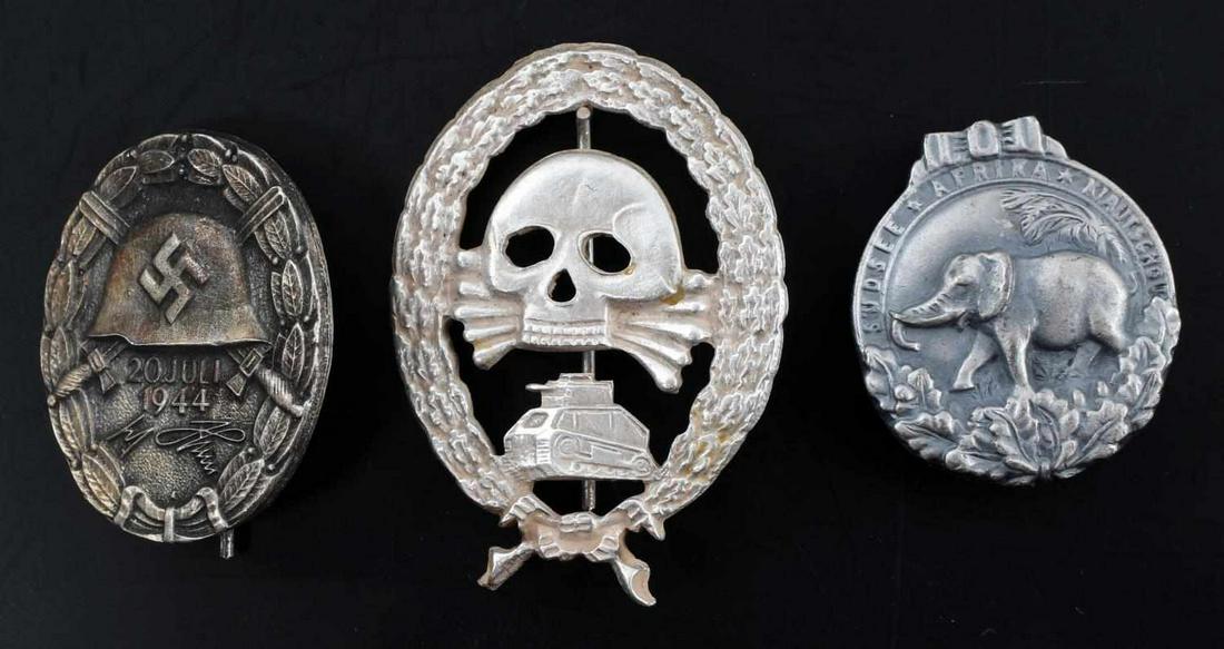 WWII GERMAN 3RD REICH TANK & WOUND BADGE LOT OF 3: This lot includes 1 Condor Legion Tank badge, 1 Afrika Colonial badge, and 1 Assassination wound badge. Wound badge facsimile signed by Adolf Hitler and reverse marked "30." Very good condition overal
