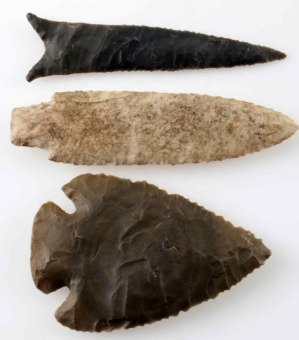 LOT OF 3 EARLY ARCHAIC STYLE ARROWHEAD POINTS: Wide Lost Lake style point made from a creamy brown lithic, wider at bottom, broad uneven flaking, sharp edges to touch, measures 3.5 inches long. Dalton style point made from creamy gray lithic, narr