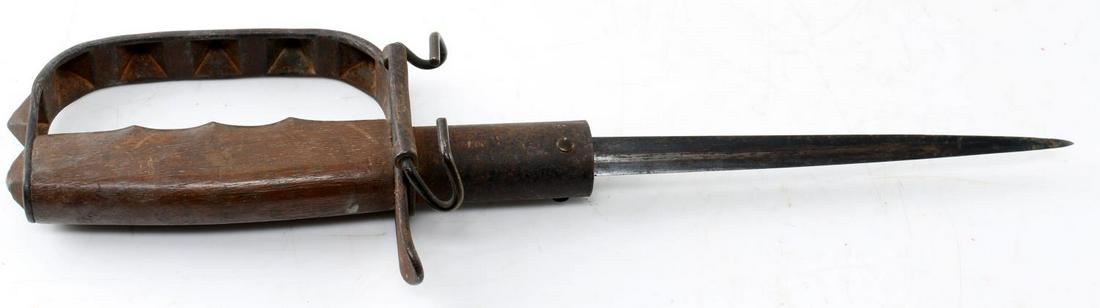 WWI US ARMY M 1917 KNUCKLE DUSTER FIGHTING KNIFE: WWI model 1917 "knuckle duster" trench knife. Includes original leather scabbard. Good with wear commensurate to age. Marked "U.S. L.F.&C. 1917" on its guard. Leather on scabbard is damaged and in nee