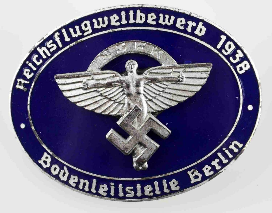 WWII GERMAN NSFK 1938 GLIDER KORPS BADGE: German NSFK Reichsflugweltbewerb Glider Korps Badge. Measures 2 3/16” wide by 1 9/16” tall. The front reads "Reichsflugweltbewerb 1938 NSFK Bodenleitstelle Berlin" Reverse maker marked "Rob Neff B
