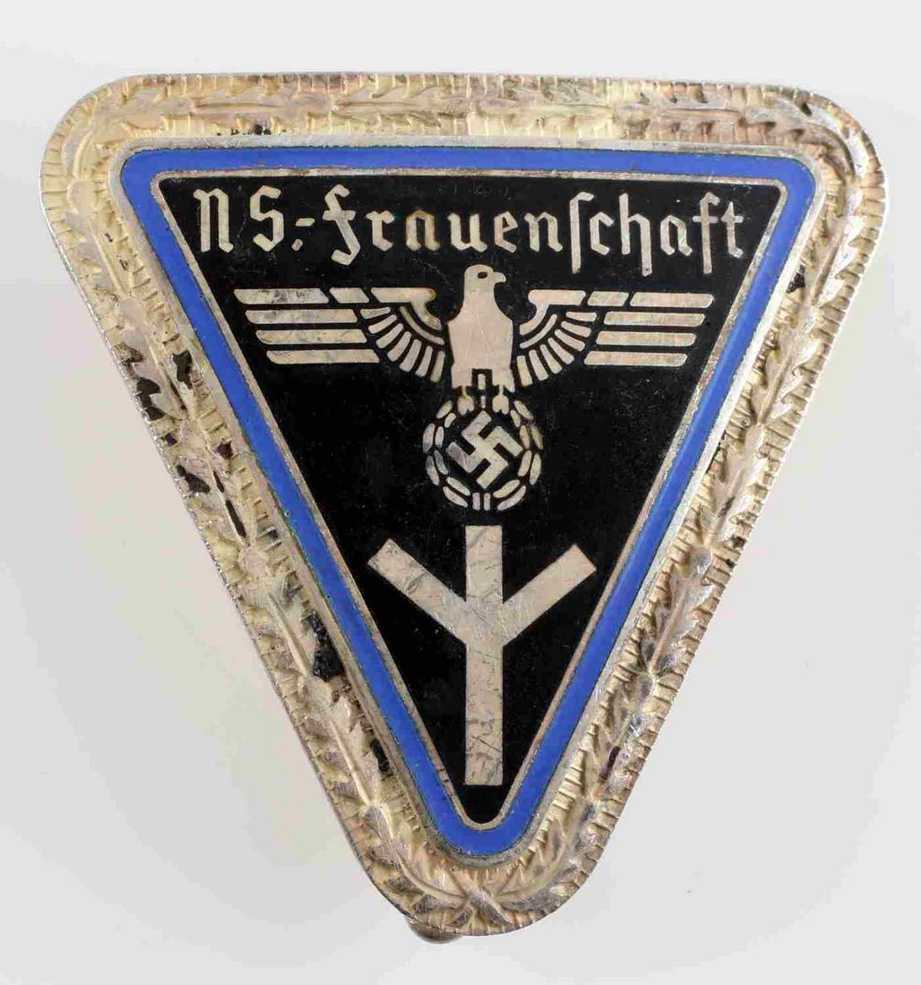 WWII GERMAN THIRD REICH NS FRAUENSCHAFT BADGE: NS Frauenschaft Badge with oak leaf border. Measures 1 3/8 inches wide by 1 7/16 inches high. Reverse is maker marked 'RZM M1/27'. Has a thin vertical pin back. Nickel construction with enamel. In ver