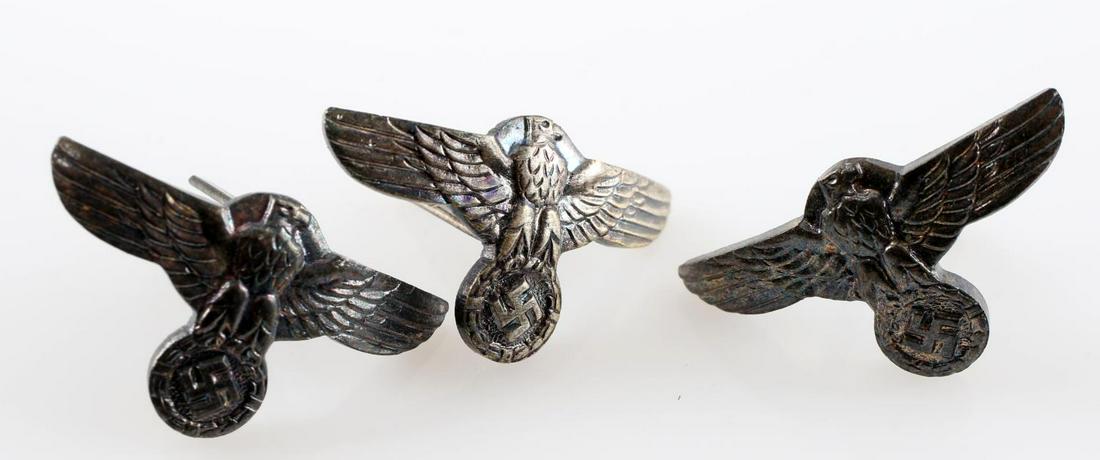 WWII GERMAN THIRD REICH SS DAGGER HANDLE EAGLE LOT: Lot contains three SS or SA dagger handle eagles. The reverse of each 'RZM M1/6'. Each has two flat prongs on the back. Nickel construction. In very good condition. Unauthenticated/Sold 'as is'.