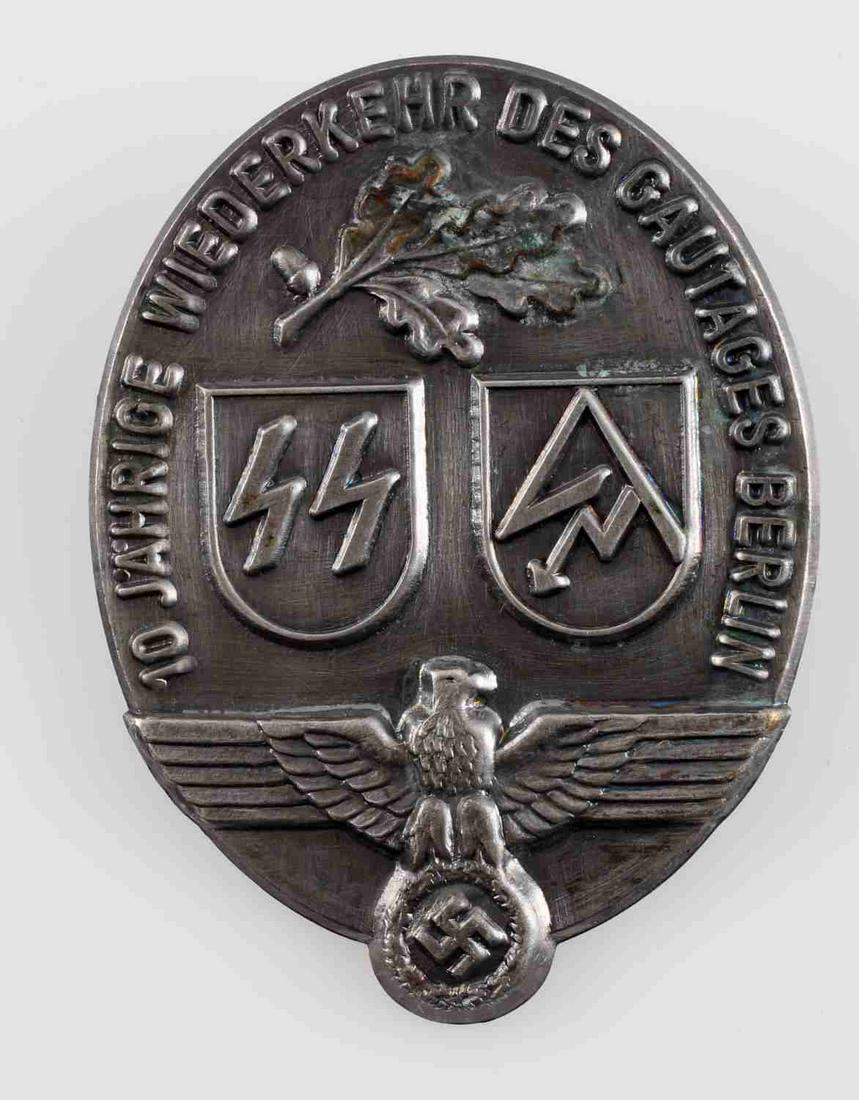 WWII GERMAN THIRD REICH SS SA GAUTAG BERLIN BADGE: Measures 1 3/8 inches wide by 1 3/4 inches high. Front shows an edelweiss at the top, the SS/SA symbol in the center, and a Reichsadler at the base. Front reads '10 Jahrige Wiederkehr Des Gautages Ber