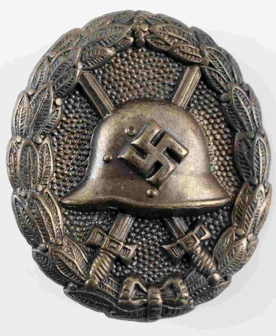 WWII GERMAN THIRD REICH CONDOR LEGION WOUND BADGE: Silver Condor Legion wound badge. Measures 1 7/16 inches wide by 1 3/4 inches tall. Has thin vertical pin back. Stamped nickel construction. In very good condition. Unauthenticated/Sold 'as is'.`