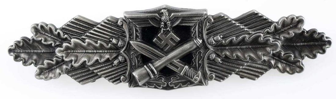 WWII GERMAN ARMY SILVER CLOSE COMBAT CLASP: Eagle with swastika at top, crossed bayonet and grenade at base and leaves out to the sides. Measures 3.75 inches long. Wide horizontal pin back with c-hook closure. 'Fec W E Peekhaus Berlin FLL' mark