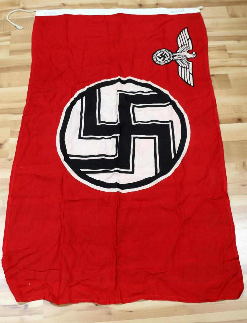 WWII GERMAN THIRD REICH NSDAP PARTY FLAG: Measures 54 7/8” wide by 33 5/8” tall. The white reinforced cotton bunting with rope on one end is maker marked "Bernard Richter Fahnerfabrik Koln Selt 1867." It is also marked "85X134." Multi pie