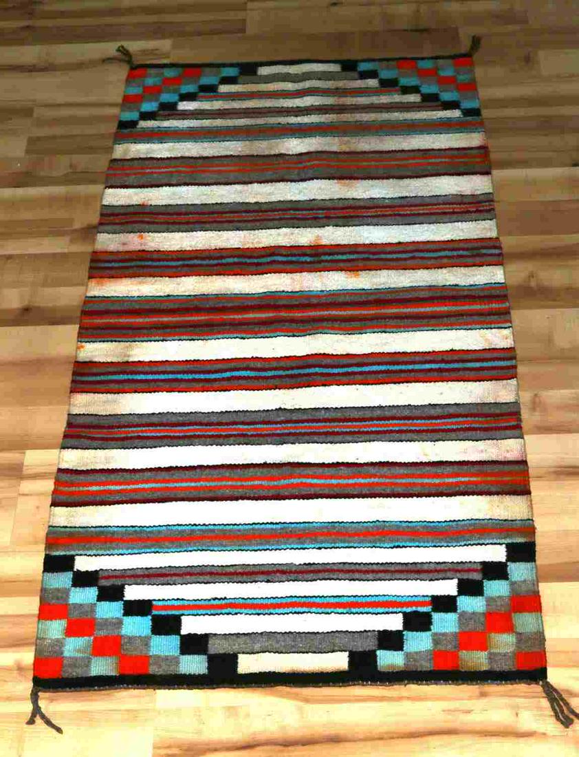 DOUBLE SIDED NAVAJO HORSE SADDLE BLANKET: Vintage Gallup Throw double sided Navajo blanket measures 60' length x 29" width. Tight weave with strong coloration. Discoloration throughout from use wear.