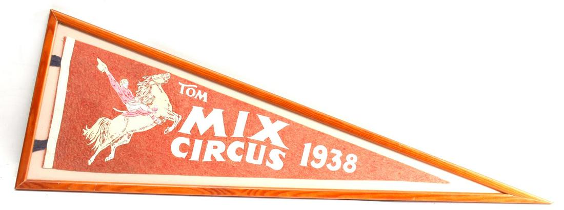 1938 TOM MIX CIRCUS PENNANT CLASSIC MEMORABILIA: Custom framed: 11 1/2" W x 35" L with 81/2" x 26" silk-screened felt pennant. Design has nice full figure art image of Tom Mix on bucking bronco. This image has color accents as produced. Felt shows s