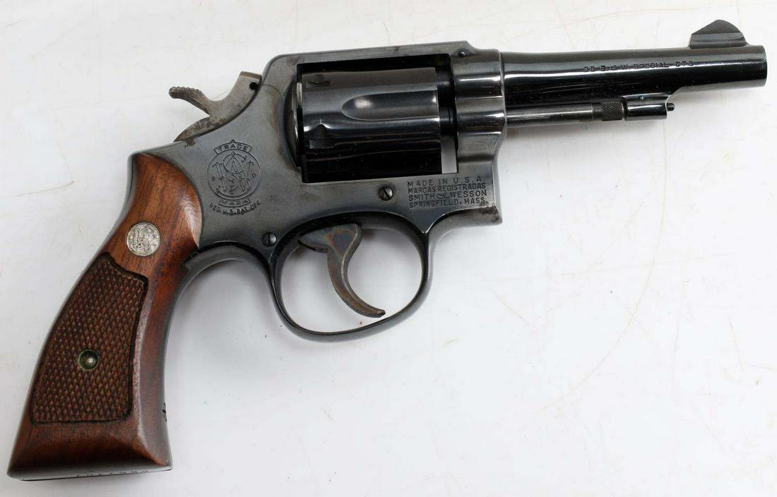 SMITH & WESSON MODEL 10 5 6 SHOT REVOLVER .38 SPL: Blued steel with 85% remaining, maker marks to both sides, model is on inside of frame, caliber is along right side barrel, barrel measures 4 inches long with bright clean bore, checkered wood grips,