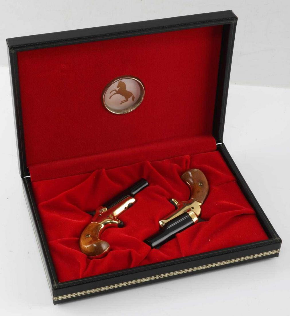 COLT LORD AND LADY DERRINGER SET .22 S WITH BOX: 1970's production. Black steel 2.5 inch barrels with good clear bores, brass frame and wood grips, clear markings, comes in red felt-lined box. One pistol has tiny rough spot where barrel opens up, ot