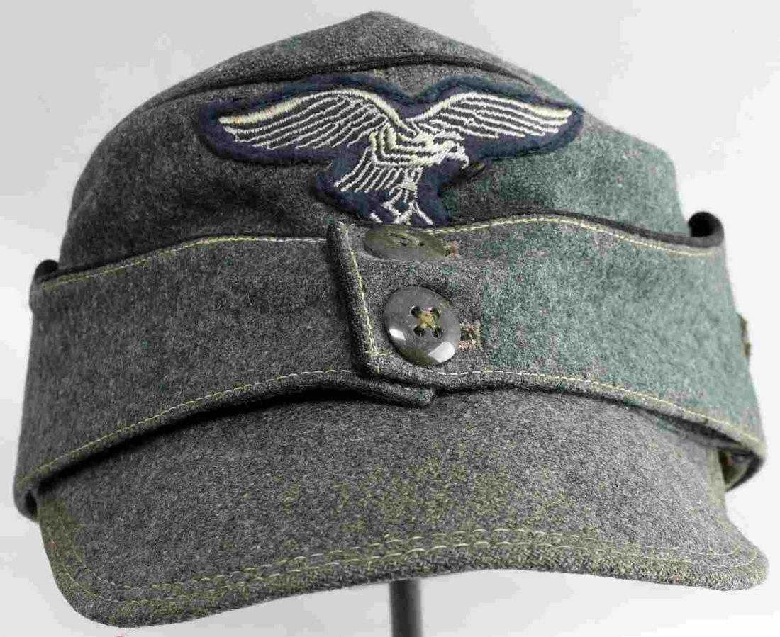 WWII GERMAN THIRD REICH LUFTWAFFE M 43 FIELD CAP: German Luftwaffe M43 field cap. Wool construction with a modified canvas interior and steel grommet vent holes at each side. Cap is likely actually a modified M42 and has what appears to be an added b