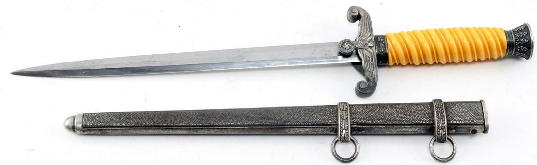 WWII GERMAN THIRD REICH ARMY OFFICER DRESS DAGGER: Dress dagger of a WWII German Army officer. Maker mark of F.W. Höller on the ricasso. Bakelite grip. Some wear to the finish of the scabbard, the crossguard, and the pommel. In very good condition.