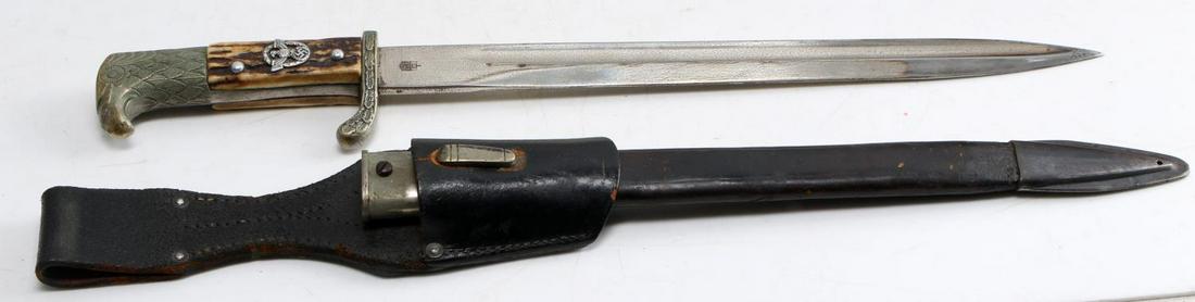 WWII THIRD REICH GERMAN DRESS BAYONET W SCABBARD: Bird's head pommel and oak leaf guard, Reichsadler in the middle of stag grip in relief, blade measures 12 7/8 inches long with Horster mark to one side and E&F Horster Solingen to other side, blade h