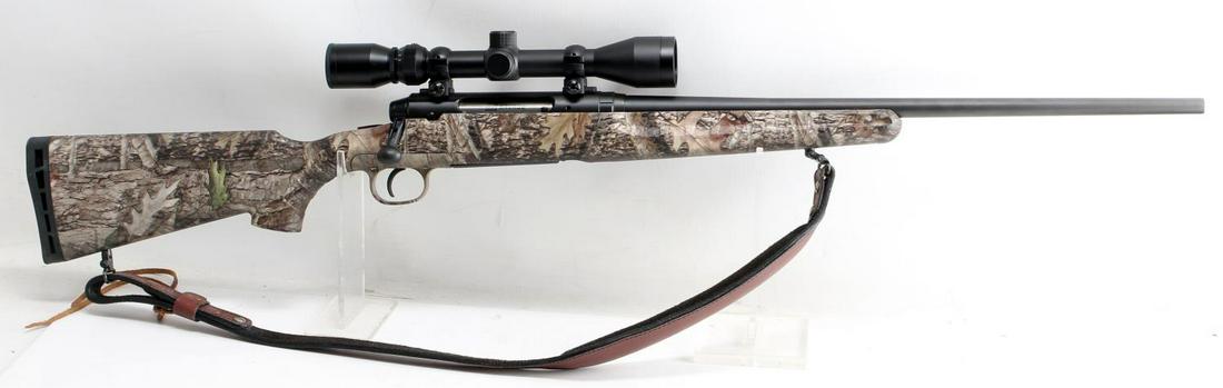 SAVAGE AXIS BOLT ACTION RIFLE .30 06 CAMO W SCOPE: Matte finish carbon steel barrel, maker marked to left side barrel, 22.5 inch barrel with fair bore, some pitting, camo synthetic stock, and rubber butt plate. Weaver 3-9 X 40 scope and leather sling 