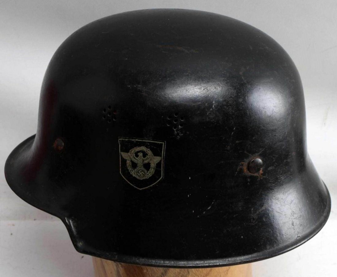 WWII GERMAN THIRD REICH M1934 POLICE HELMET: German M1934 police helmet. Has polizeiadler and tri color national shield decals and is marked "A" and a stylized "RR" at rear of shell. Missing interior lining and chin strap. Good with this excepti
