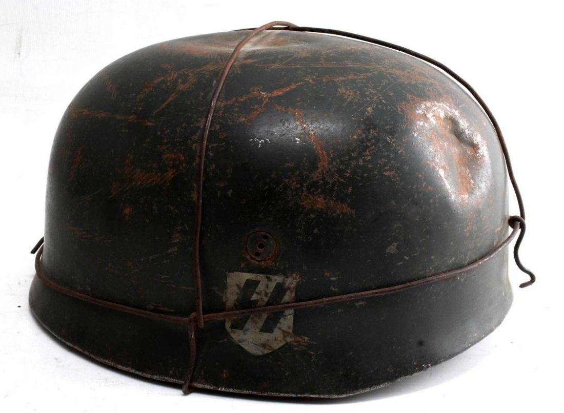 WWII GERMAN WAFFEN SS FALLSCHIRMJAGER HELMET: German SS Fallschirmjager helmet. Camo paint with double S sig rune decal at one side and national tri-color national shield at the other. In extremely good condition for its age. Marked "Baumuster: H