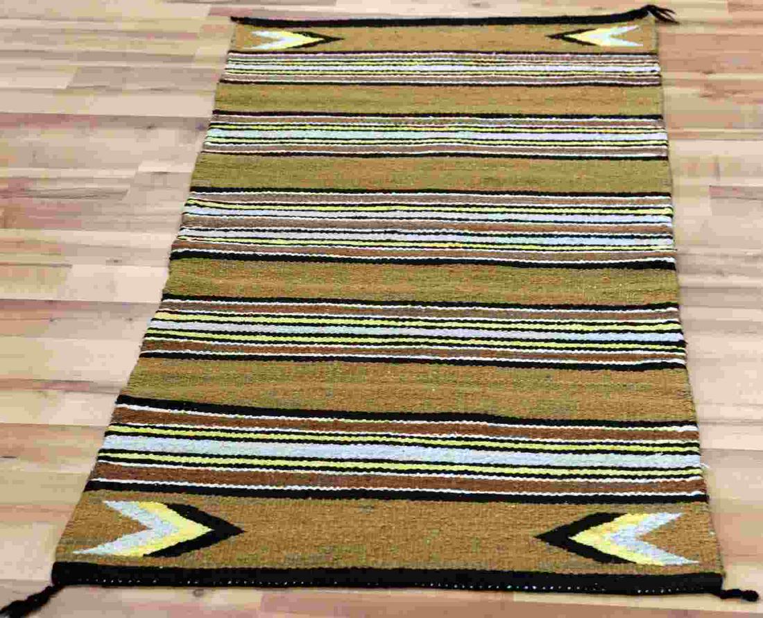 STRIPED MULTICOLORED NAVAJO SADDLE BLANKET: Multicolored striped Navajo saddle blanket. Colors are vivid and blanket is in good condition with one missing tassel. Measures 60.5 inches by 29.25 inches.