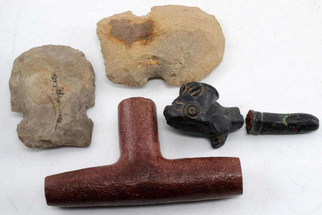 LOT 4 NATIVE AMERICAN ARTIFACTS MODERN PRODUCTION: Two axe head blades (4, 4.5 inches), catlinite pipe (has pitting) (6 inches), and a broken clay pipe with mask face (5 inches). Condition varies. Modern reproduction.