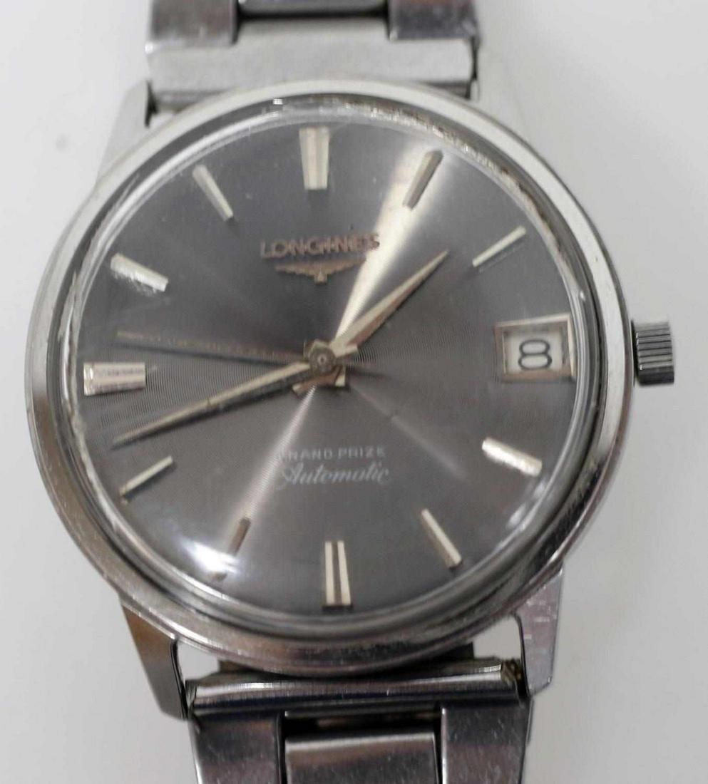VINTAGE LONGINES GRAND PRIZE AUTOMATIC WATCH: Longines Grand Prize automatic watch. In good condition with some scratches on the crystal. Has "R.T." etched on the back. Movement runs well, though should be serviced on purchase.