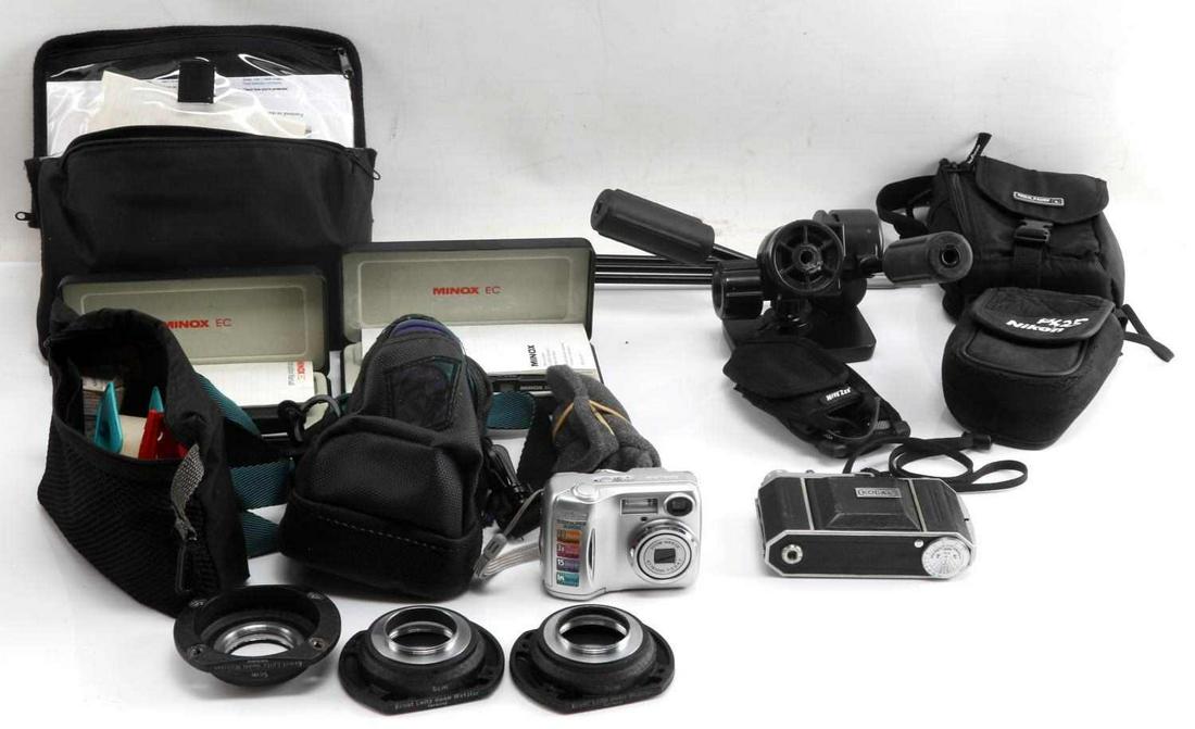 LOT OF CAMERAS & ACCESSORIES KODAK RETINA NIKON: Four Minox cameras with multiple cases of color film. Nikon Coolpix. Tape over one button. Kodak Retina vintage camera. Leitz camera stand, missing one leg. Velbon PH-460 movable camera mount. Three s