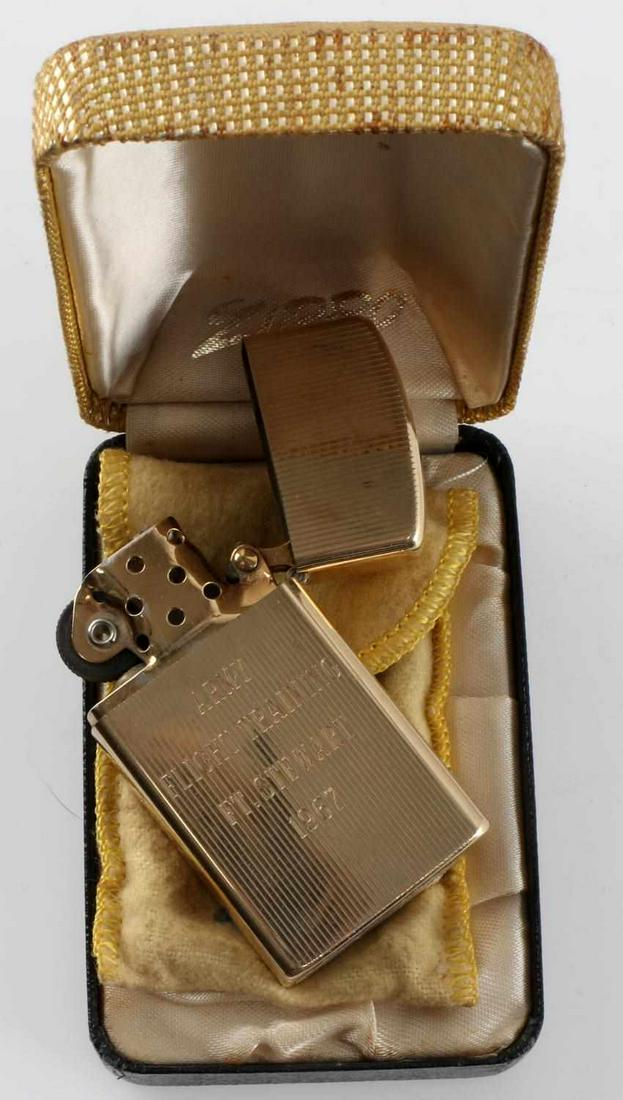 1967 VIETNAM PILOT GOLD PLATED ZIPPO LIGHTER: Engraved AKS on front and ARMY FLIGHT TRAINING Ft. Stewart 1967 on reverse. Gold plated in excellent condition. Original felt pouch and box.