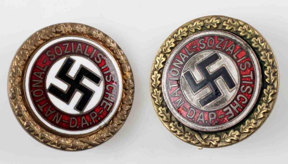 WWII GERMAN THIRD REICH GOLDEN PARTY BADGE LOT: This lot includes 2 German NSDAP golden party badges. Both are reverse etched "Ges. Gesch." One is etched "15/16 II 1939" and is etched with facsimile signature of Adolf Hitler. The other is reverse m