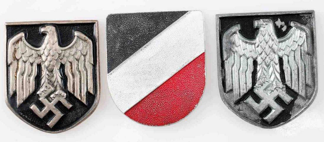 WWII GERMAN ARMY PITH HELMET SHIELD LOT OF THREE: WWII German Army pith helmet shield lot of three. The lot includes two army pith shields and a national colors badge. One pith shield showcases the black fading on the front and stamped K.W on the rea