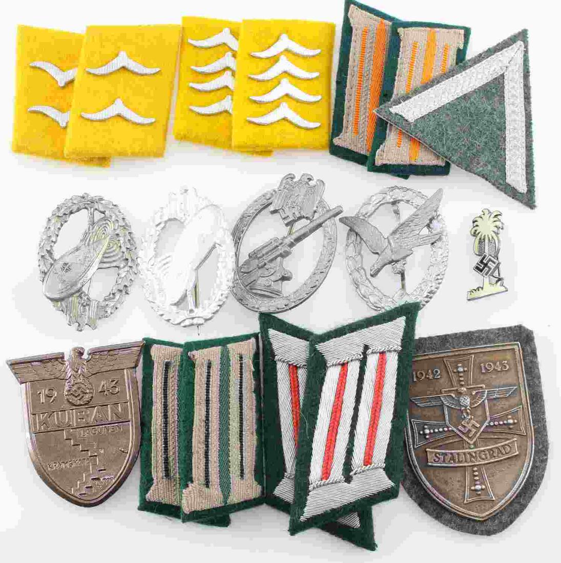 WWII GERMAN THIRD REICH BADGE AND COLLAR LOT OF 13: Lot includes variety of collar tabs, badges, shields (Kuban and Stalingrad) and a Chevron. There are makers marks on the badges. Condition ranges from good to very good. Unauthenticated; sold as is.