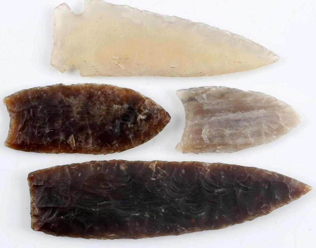 LOT OF FOUR NATIVE AMERICAN PALEO ARROWHEADS: One larger Clovis of dark brown lithic with parallel flaking measuring 4.25 inches. One Clovis of dark brown lithic with nice narrow flaking measuring 2.5 inches. One Clovis of striated gray lithic wi