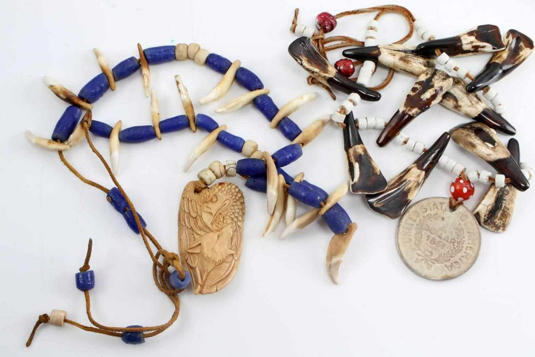 NATIVE AMERICAN BUFFALO TOOTH AND BEAR NECKLACE: Native American Buffalo Tooth and Brown Bear Claw Necklace. Lot includes one Buffalo tooth necklace with 10 buffalo teeth, white beads and a token coin pendant in the center. The Brown Bear claws cons