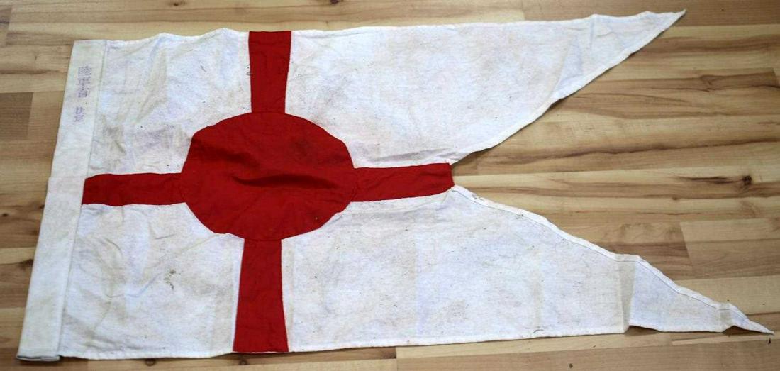WWII IMPERIAL JAPANESE NAVY COMMANDER PENNANT: Japanese Navy Flotilla Commanders pennant. Measures about 35 inches at its longest point. Ink stamped in purple Japanese characters at its end. No rope. Shows wear and some staining. This lot has a re