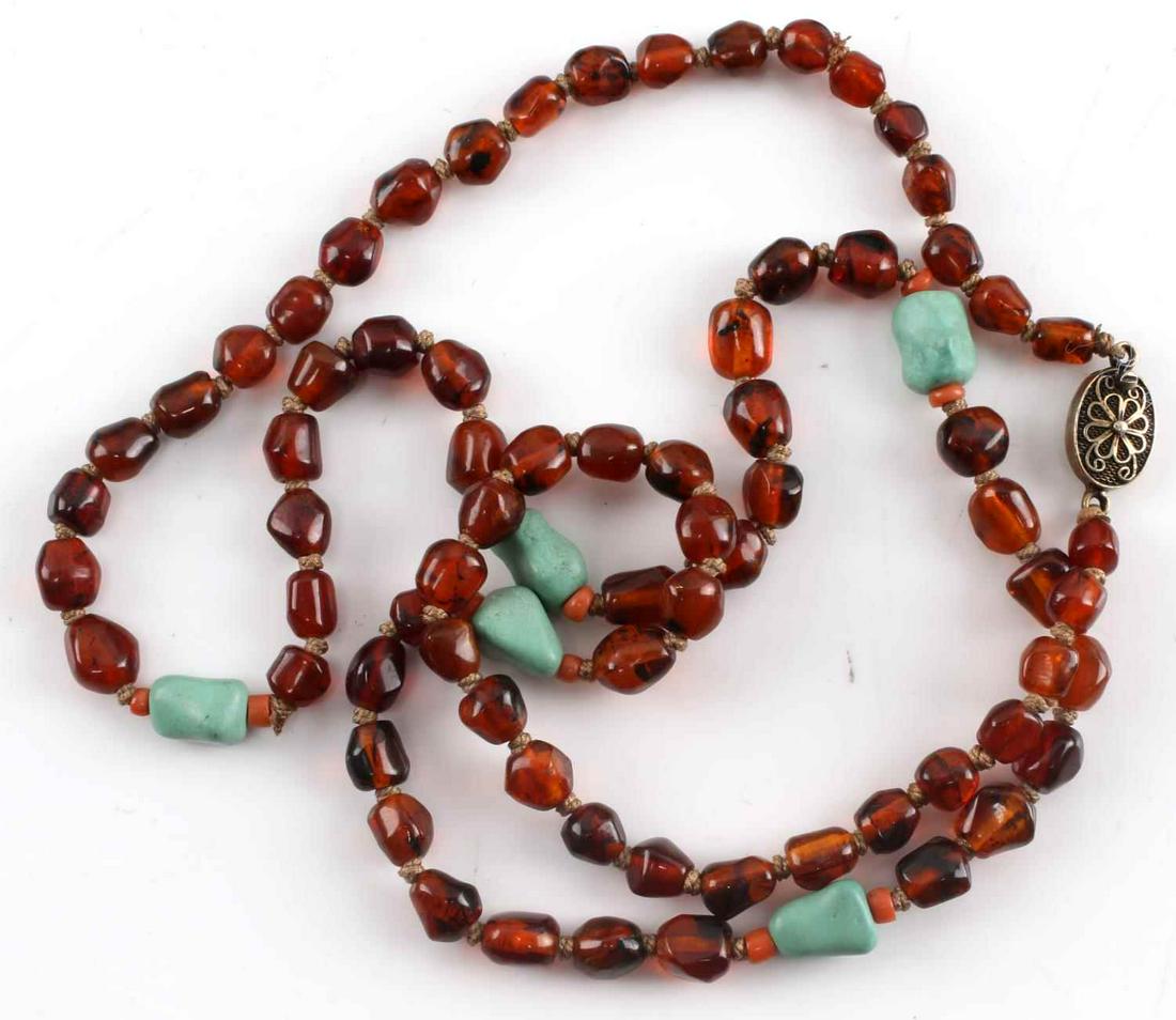 NATIVE AMERICAN DOMINICAN AMBER NECKLACE 21 INCHES: Native American Dominican Amber Necklace 21 inches. Lot consists of Amber and Chrysoberyl. Each stone measures roughly 13MM. The pendant on the necklace is composed of silver. Lot is in very good cond