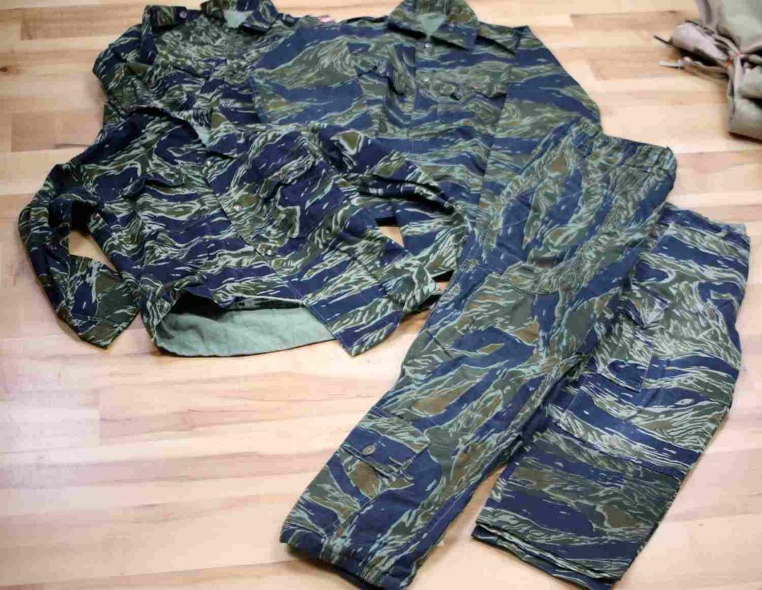 2.5 CHILDRENS VIETNAMESE TIGER STRIPE CAMO UNIFORM: 2.5 Childrens Vietnamese Tiger Stripe Camo uniforms. lot includes three tiger stripe jackets and two pairs of tiger stripe pants. These were custom made in Thailand and one jacket has a Thailand patch